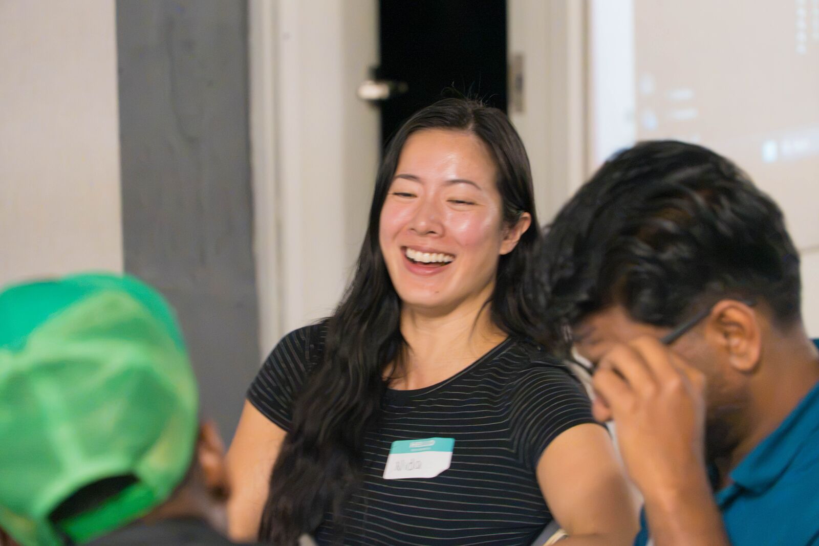 Two attendees laugh together at a table during the build.