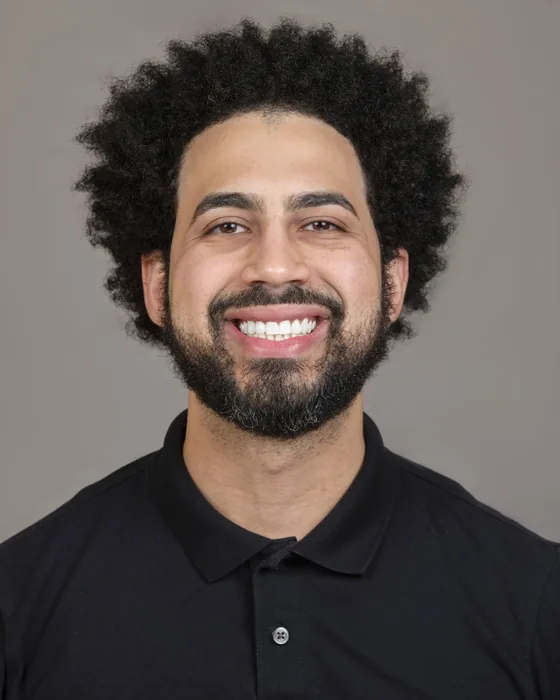 Waskar Paulino, smiling, in a black polo shirt